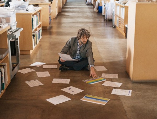 Man organizing documents in library --- Image by © Hiya Images/Corbis